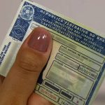 Mão segurando CNH; validade da CNH